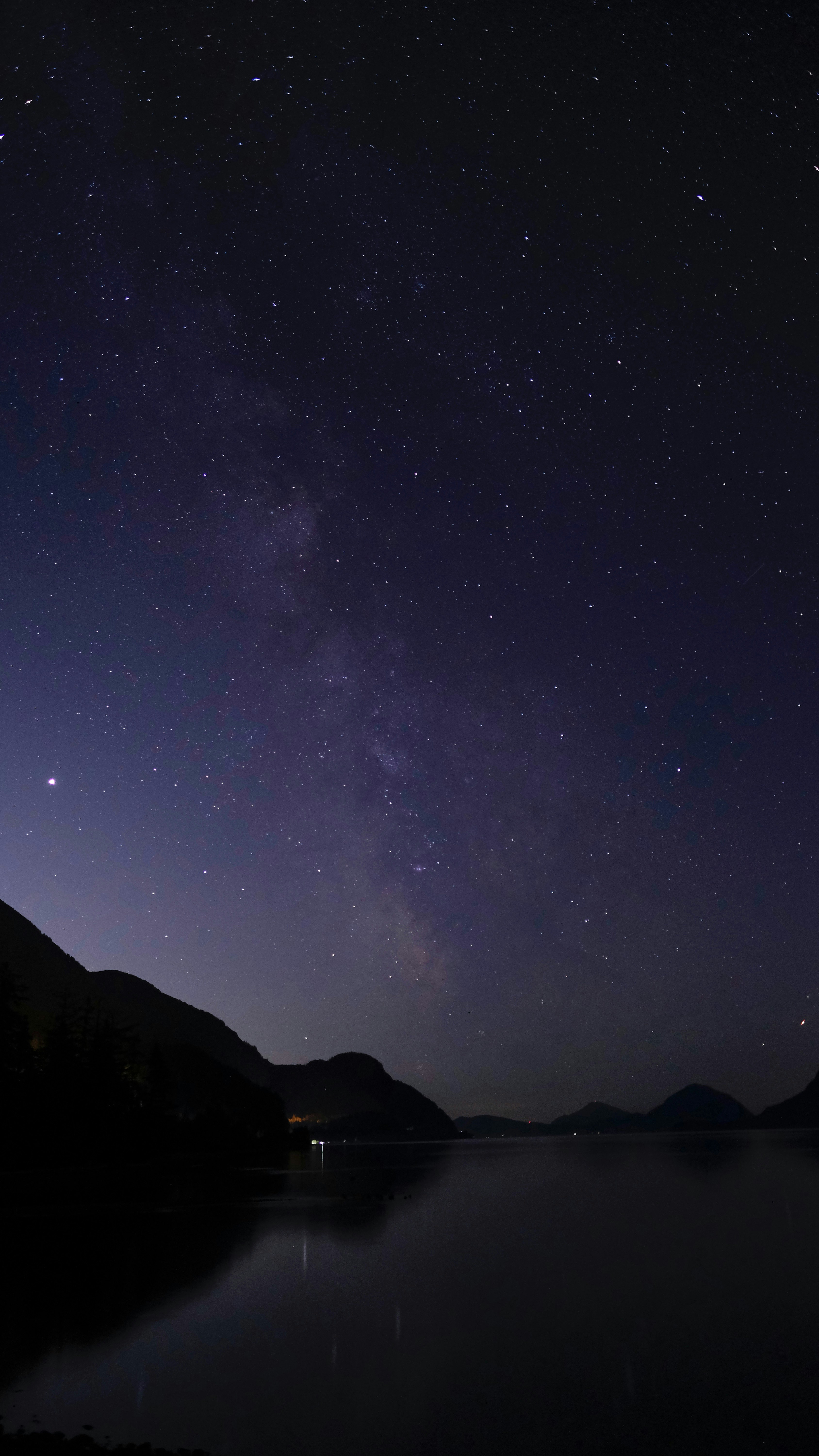 silhouette of mountain under starry night